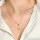 Gold snake pendant necklace with zircon-studded pendant at the neckline