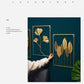 Gold metal leaf wall hanging set of framed botanical designs on a teal wall