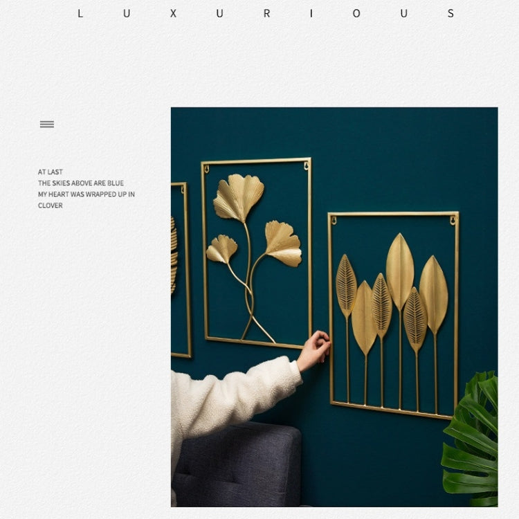 Gold metal leaf wall hanging set of framed botanical designs on a teal wall