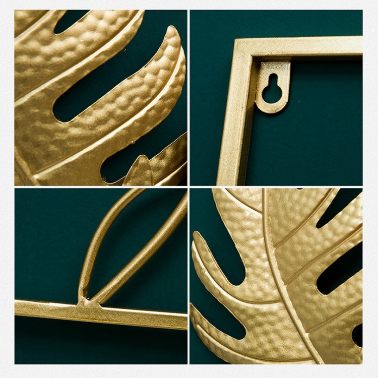 Gold metal leaf wall hanging close-up showing textured leaf cutouts in frame