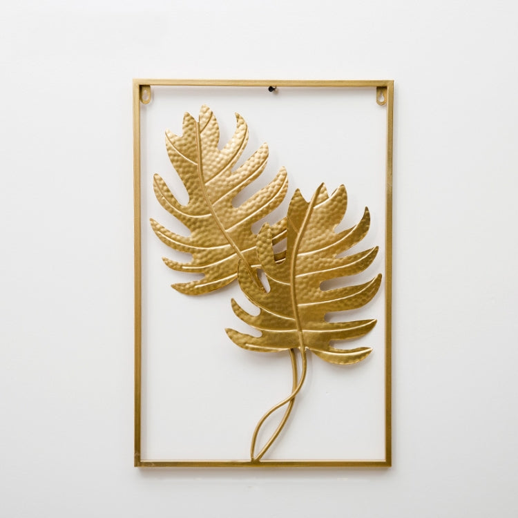 Gold metal leaf wall hanging in rectangular frame with large layered leaf cluster