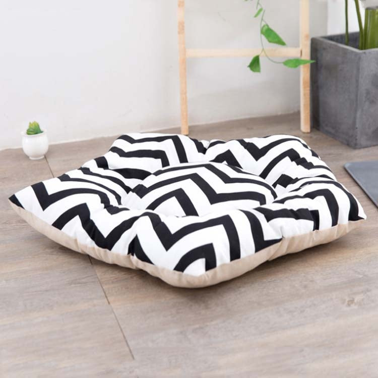 Pet sleeping mat bed with black-and-white zigzag patterned cover and beige bottom edge