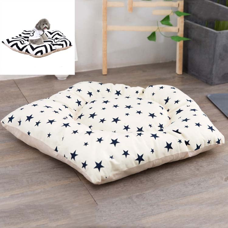 Dog sleeping mat bed with white fabric and navy star print, padded cream edges
