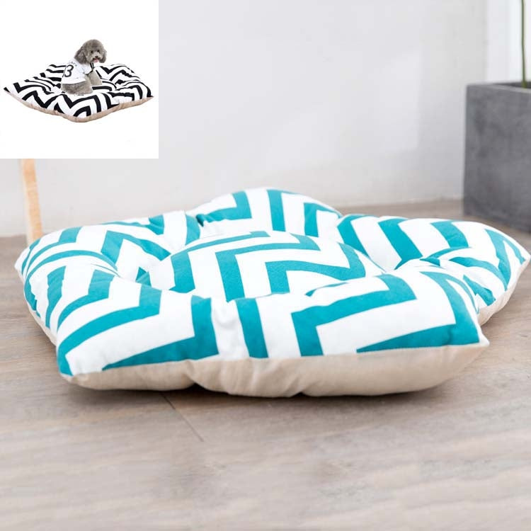 Dog sleeping mat bed with bold turquoise geometric shapes on white top and cream base