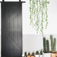 Green leaf dangling wall stickers draped in a curved cluster near potted plants
