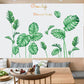 Green botanical leaf wall decals arranged on a living room wall