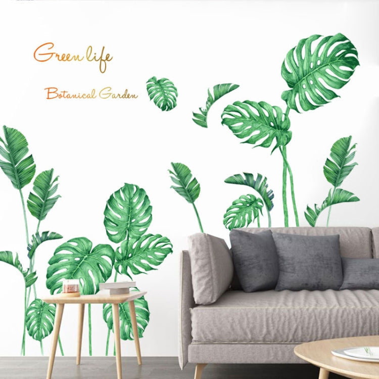 Green tropical leaf wall stickers on a sofa wall with living room seating