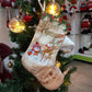 Beige Christmas stocking with 'Merry Christmas' and winter character print, hanging.