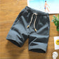 Dark green cotton-linen five-point shorts with elastic waistband and drawstring, relaxed fit