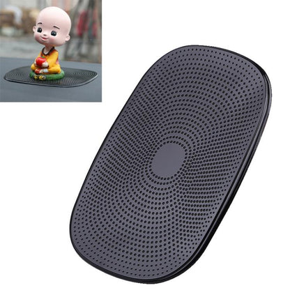 Oval black anti-slip nano pad with dense dot grip surface and center ring