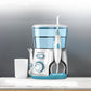 Water flosser oral irrigator with blue-tinted reservoir and handheld nozzle with tips