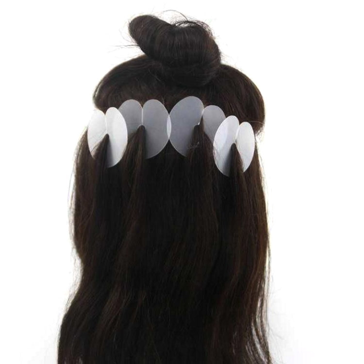 Black hair extension wig with white anti-scalding film tabs attached across the back