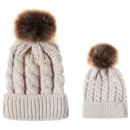 Parent-child knit beanie set in light khaki/cream with brown faux-fur pom pom tops