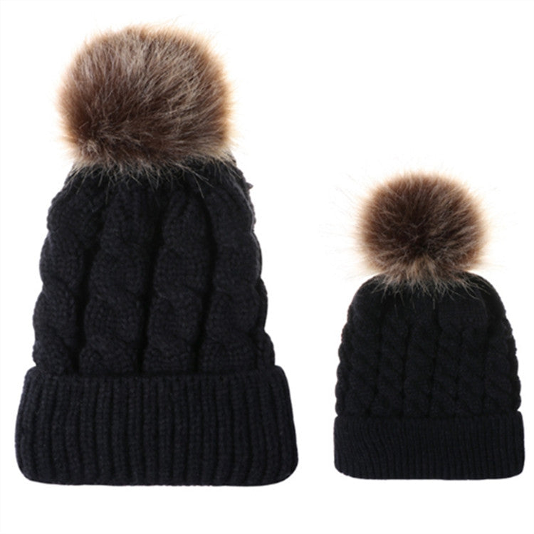 Parent-child knit beanie set in black with brown faux-fur pom pom tops