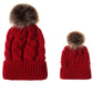Parent-child knit beanie set in red with brown faux-fur pom pom and ribbed band