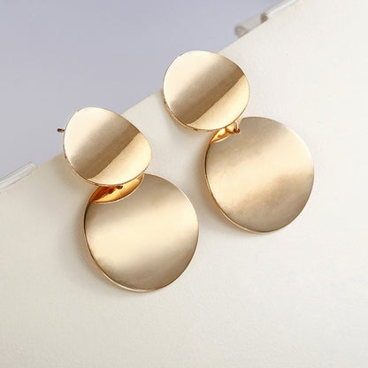 Gold-tone round drop statement earrings with three stacked discs and hook backs.