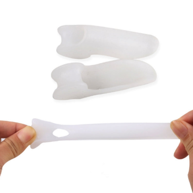 Two single-hole toe separation pads held in hands, light color