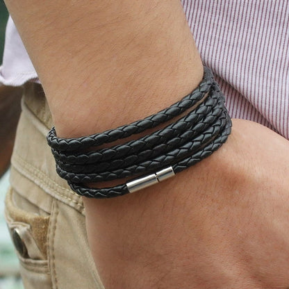 Black braided leather wrap bracelet with silver-tone bar clasp on wrist