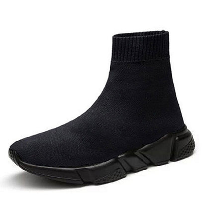 Black knit sock sneaker boot with chunky dark sole and ribbed ankle cuff