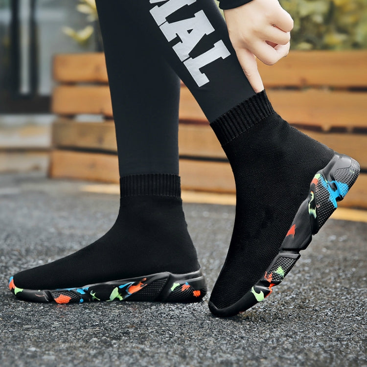 Black knit sock sneaker boots with ribbed cuffs and colorful outsole