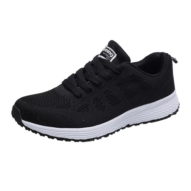 Women's black mesh lace-up running sneakers with white cushioned sole