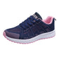 Women's navy mesh lace-up running sneakers with pink lining and white sole