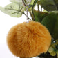 Orange faux rabbit fur pompon keychain with silver chain and key ring