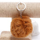 Brown faux rabbit fur pompon keychain with silver key ring and chain
