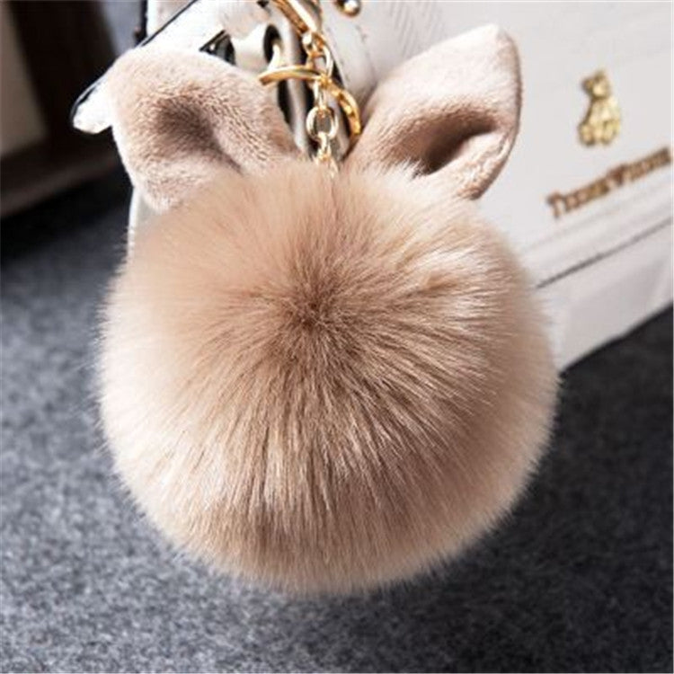 Beige faux-fur ball keychain with bunny ears and gold-tone clasp
