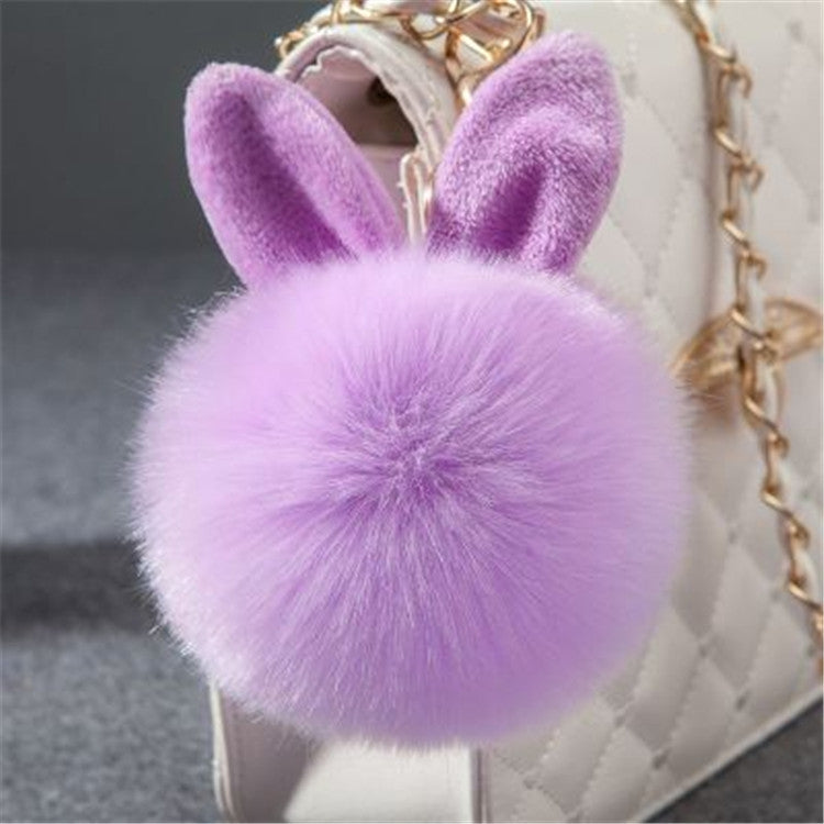 Light purple faux-fur ball keychain with bunny ears and gold-tone clasp