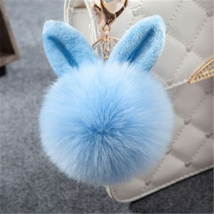 Light blue faux-fur rabbit pom keychain with long ears and gold-tone clasp