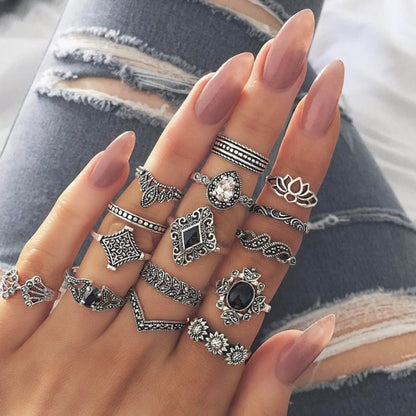 Silver-tone vintage rings on fingers with black and clear oval and square stones