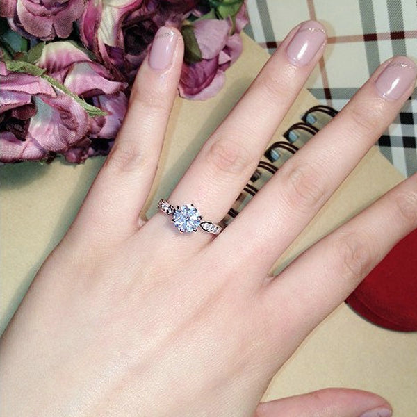 Six-claw crystal solitaire ring with silver-tone band