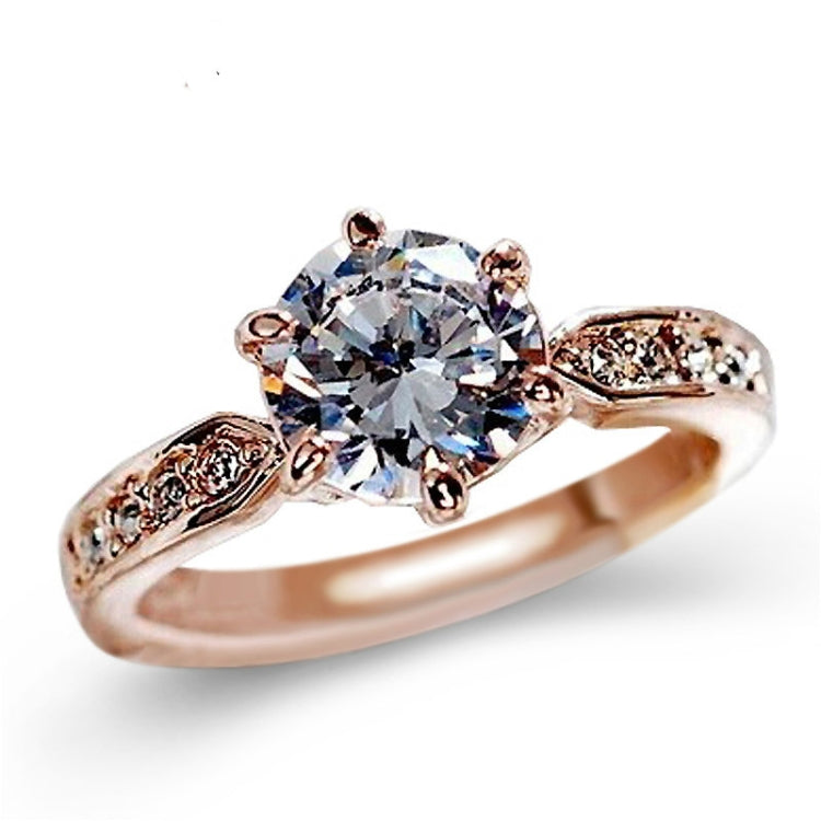 Rose gold crystal six-claw ring with large round center stone and engraved side sections