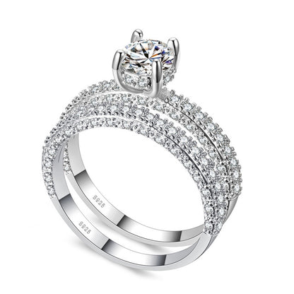 Double-row cubic zirconia ring set in silver tone with round center stone