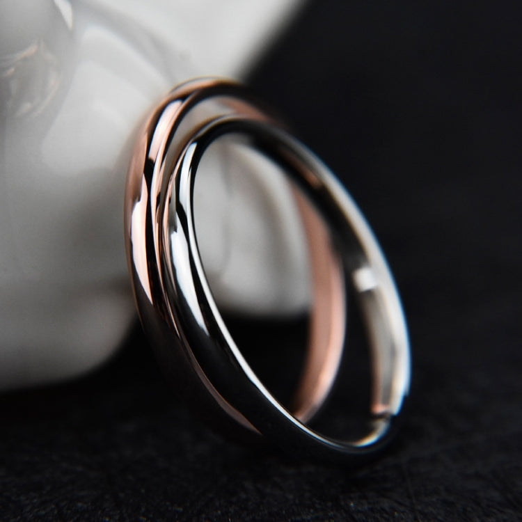 Shiny black and silver stainless steel ring with a rose-tone highlight