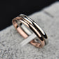 Stacked two-tone rings with rose gold and black polished metal bands