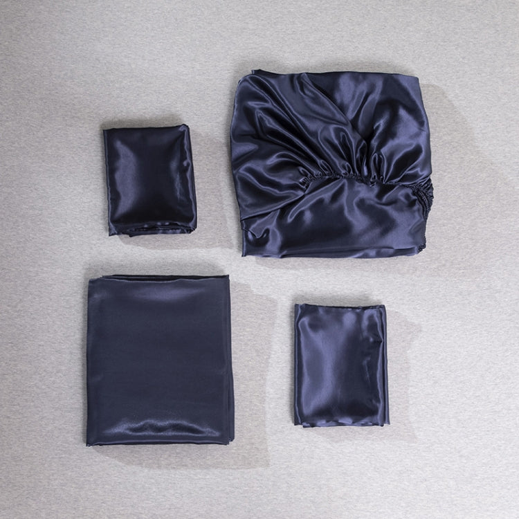Navy silk-look bedding set pieces laid out: pillowcase squares and sheet fabric