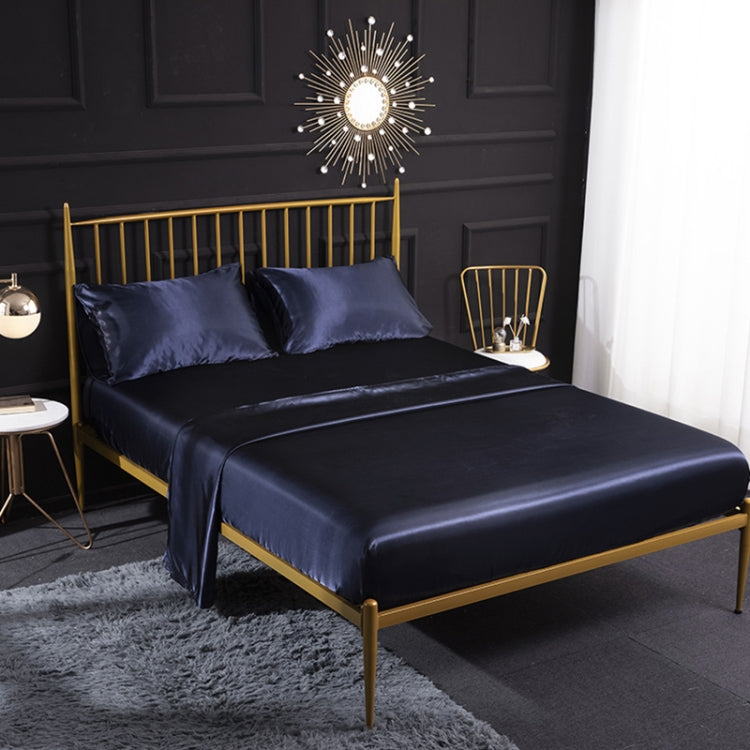 Royal blue silk-look sheet set with two pillowcases, fitted and flat sheets on bed