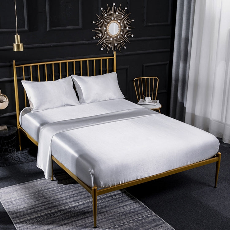 White silk-look sheet set with two pillowcases, fitted and flat sheets on bed