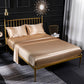 Beige satin-look four-piece bedding set with pillowcases and fitted sheet on bed
