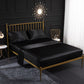Black satin-look four-piece bedding set with pillowcases and fitted sheet on bed