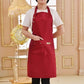 Red kitchen apron with adjustable neck strap and two front pockets.