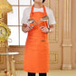 Orange kitchen apron worn over a white shirt, with front bib and pouch pocket.