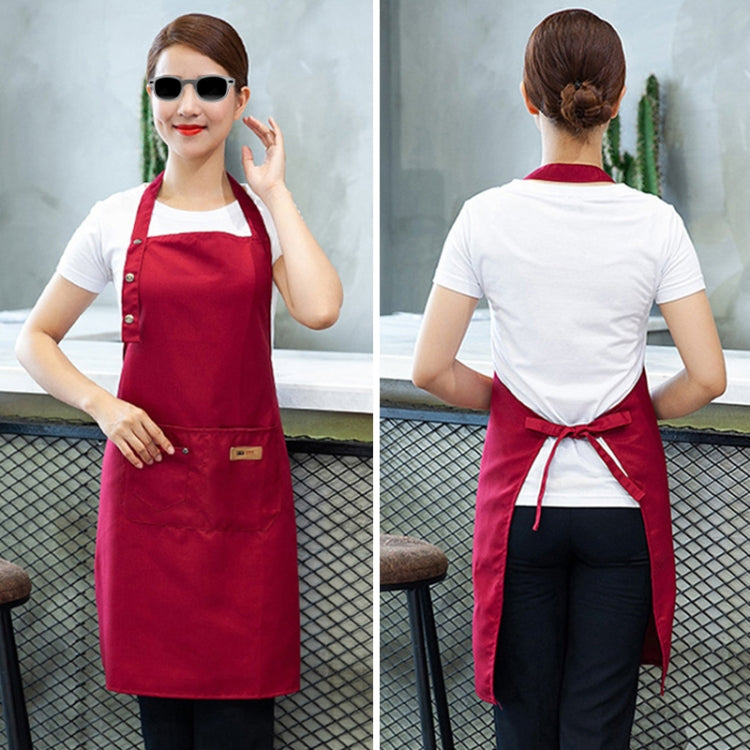 Red kitchen apron in back view, tied waist and adjustable neck strap.