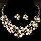Gold leaf necklace and faux-pearl earrings set with crystal leaf details
