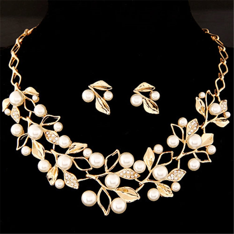 Gold leaf necklace and faux-pearl earrings set with crystal leaf details
