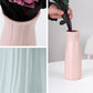 Pink ribbed plastic vase with vertical flutes, tall desktop flower holder