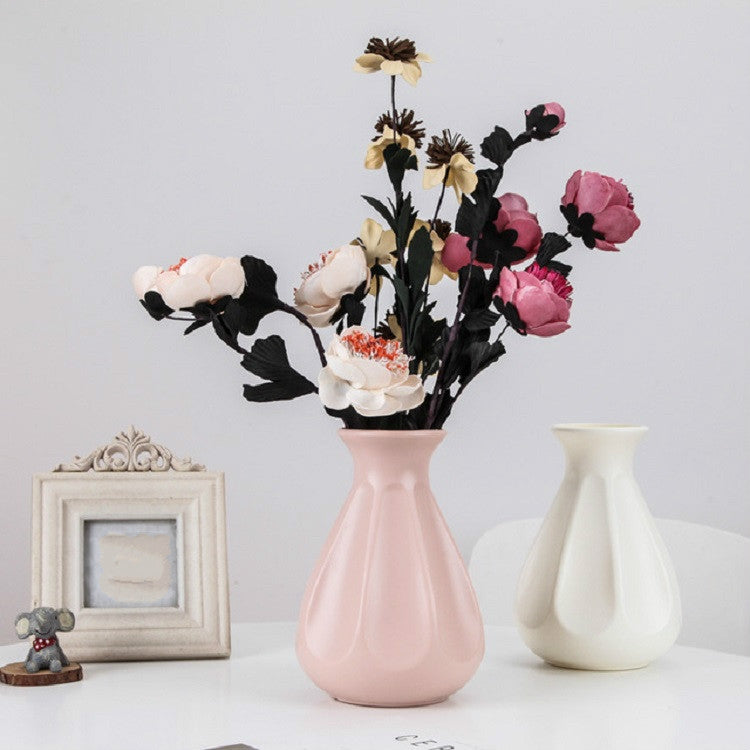 Pink plastic vase centerpiece with faux flower bouquet and matching white vase