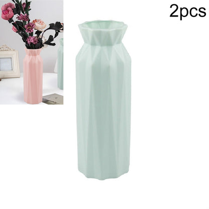 Light green plastic round vase with faceted sides, wide top opening, tall cylinder shape